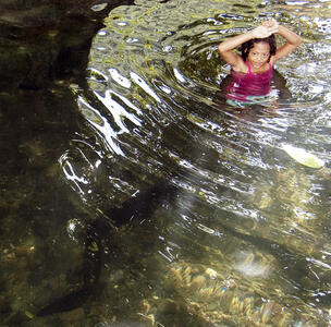 Before entering the water, children rub special leaves to cover their skin with the leaves' oil to avoid being bitten by the eels.
